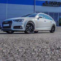 ABS Wheels F15 Black alloy wheel mounted on car in an atmospheric setting