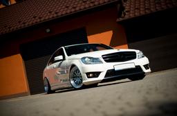 JR Wheels JR10 Silver alloy wheel mounted on car in an atmospheric setting