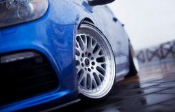 JR Wheels JR10 Silver alloy wheel mounted on car in an atmospheric setting