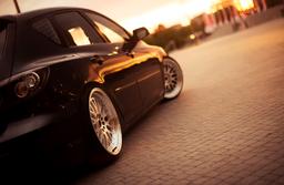 JR Wheels JR10 Silver alloy wheel mounted on car in an atmospheric setting