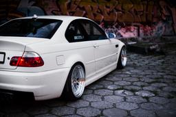 JR Wheels JR10 Silver alloy wheel mounted on car in an atmospheric setting