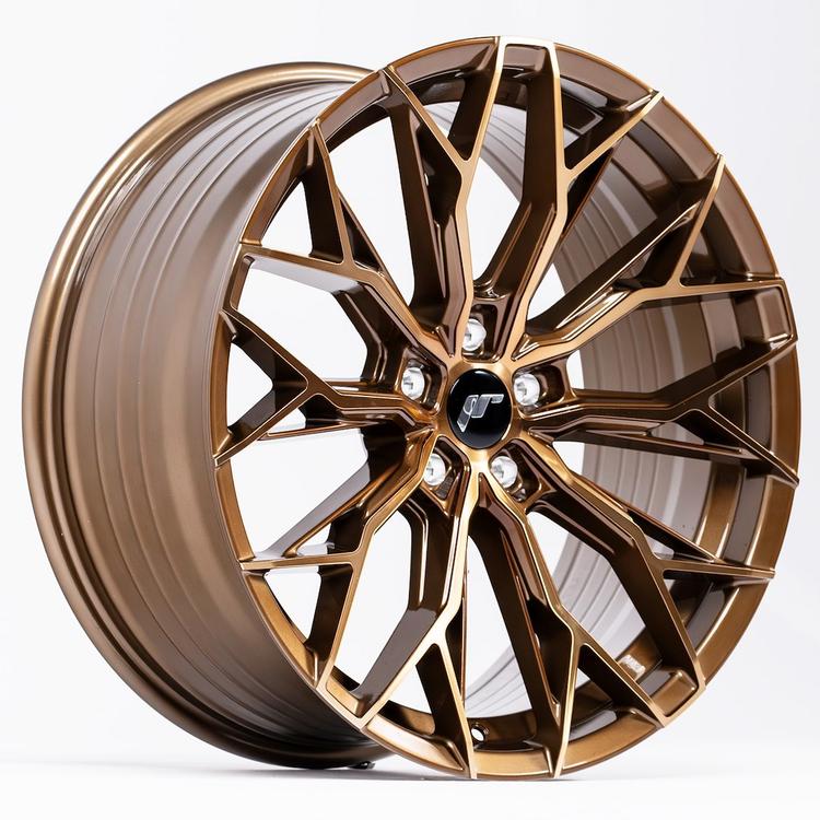 JR Wheels JR49 Bronze alloy wheel mounted on car in an atmospheric setting