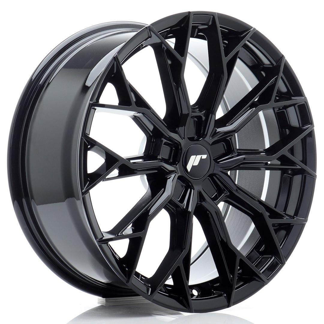 JR Wheels JR49 Black alloy wheel mounted on car in an atmospheric setting
