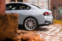 JR Wheels JR49 Silver alloy wheel mounted on car in an atmospheric setting