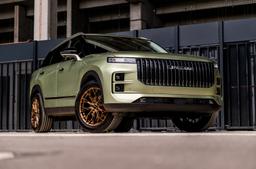 JR Wheels JR49 Bronze alloy wheel mounted on car in an atmospheric setting