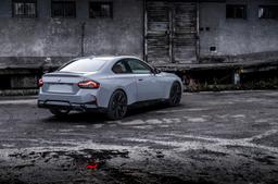 JR Wheels JR50 Black alloy wheel mounted on car in an atmospheric setting