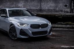 JR Wheels JR50 Black alloy wheel mounted on car in an atmospheric setting