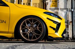 JR Wheels JR51 Bronze alloy wheel mounted on car in an atmospheric setting