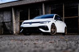 JR Wheels JR51 Bronze alloy wheel mounted on car in an atmospheric setting