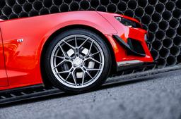 JR Wheels JR51 Silver alloy wheel mounted on car in an atmospheric setting