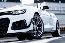 JR Wheels JR51 Silver alloy wheel mounted on car in an atmospheric setting