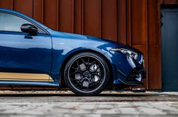 JR Wheels JR51 Black alloy wheel mounted on car in an atmospheric setting