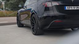 Imaz Wheels FF675 Black alloy wheel mounted on car in an atmospheric setting