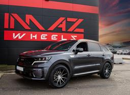 Imaz Wheels FF499 Black alloy wheel mounted on car in an atmospheric setting