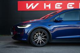 Imaz Wheels FF499 Black alloy wheel mounted on car in an atmospheric setting