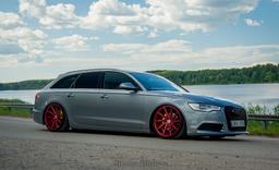 Imaz Wheels IM5L Red alloy wheel mounted on car in an atmospheric setting