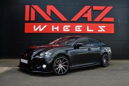 Imaz Wheels IM5R Black alloy wheel mounted on car in an atmospheric setting