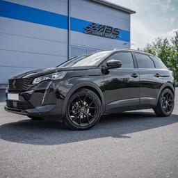 ABS Wheels F21 Black alloy wheel mounted on car in an atmospheric setting