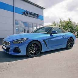 ABS Wheels F21 Black alloy wheel mounted on car in an atmospheric setting