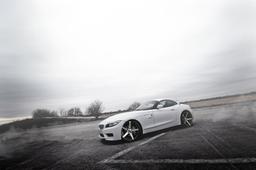 ABS Wheels 355 Black alloy wheel mounted on car in an atmospheric setting