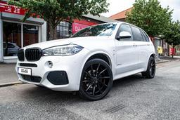 Imaz Wheels IM5R Black alloy wheel mounted on car in an atmospheric setting