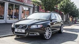 Imaz Wheels IM5R Silver alloy wheel mounted on car in an atmospheric setting