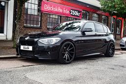 Imaz Wheels IM5R Black alloy wheel mounted on car in an atmospheric setting