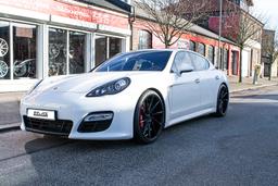 Imaz Wheels IM5R Black alloy wheel mounted on car in an atmospheric setting
