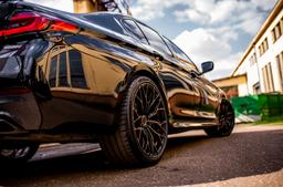 Concaver CVR1 Black alloy wheel mounted on car in an atmospheric setting