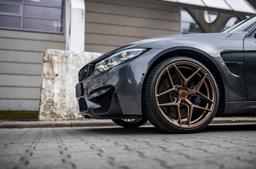 Concaver CVR2 Bronze alloy wheel mounted on car in an atmospheric setting