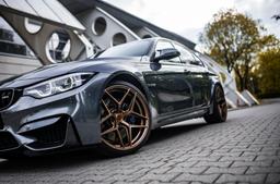 Concaver CVR2 Bronze alloy wheel mounted on car in an atmospheric setting