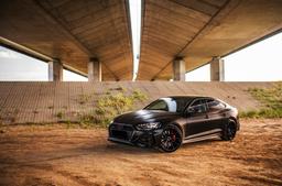 Concaver CVR4 Black alloy wheel mounted on car in an atmospheric setting