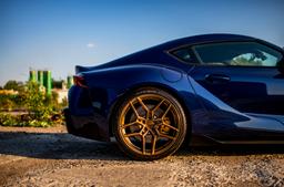 Concaver CVR5 Bronze alloy wheel mounted on car in an atmospheric setting