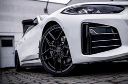 Concaver CVR5 Black alloy wheel mounted on car in an atmospheric setting