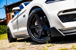 Concaver CVR9 Black alloy wheel mounted on car in an atmospheric setting