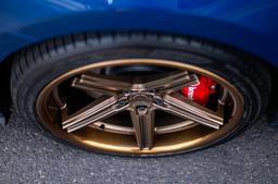 Concaver CVR9 Bronze alloy wheel mounted on car in an atmospheric setting