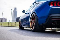Concaver CVR9 Bronze alloy wheel mounted on car in an atmospheric setting