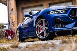 Concaver CVR9 Silver alloy wheel mounted on car in an atmospheric setting