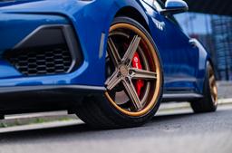 Concaver CVR9 Bronze alloy wheel mounted on car in an atmospheric setting