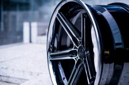Concaver CVR9 Black alloy wheel mounted on car in an atmospheric setting