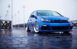 JR Wheels JR10 Silver alloy wheel mounted on car in an atmospheric setting