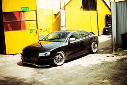 JR Wheels JR10 Silver alloy wheel mounted on car in an atmospheric setting