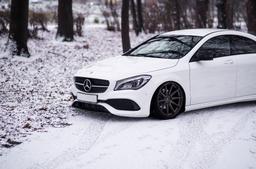 JR Wheels JR11 Bronze alloy wheel mounted on car in an atmospheric setting