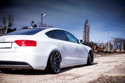 JR Wheels JR11 Grey alloy wheel mounted on car in an atmospheric setting