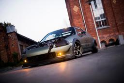 JR Wheels JR12 Bronze alloy wheel mounted on car in an atmospheric setting