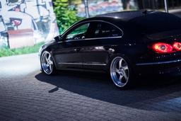 JR Wheels JR15 Silver alloy wheel mounted on car in an atmospheric setting