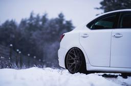 JR Wheels JR18 Bronze alloy wheel mounted on car in an atmospheric setting