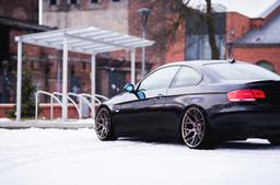 JR Wheels JR18 Bronze alloy wheel mounted on car in an atmospheric setting