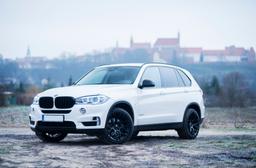 JR Wheels JR18 Black alloy wheel mounted on car in an atmospheric setting