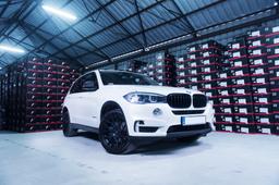 JR Wheels JR18 Black alloy wheel mounted on car in an atmospheric setting